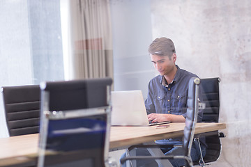 Image showing businessman working using a laptop in startup office