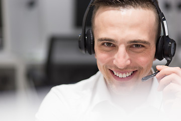 Image showing male call centre operator doing his job