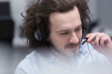 Image showing male call centre operator doing his job