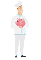 Image showing Caucasian chef cook holding a piggy bank.