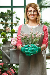 Image showing Florist with flowers at store