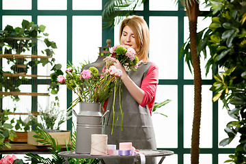 Image showing Woman making composition of flowers