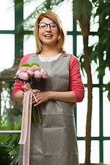 Image showing Woman with bouquet in shop