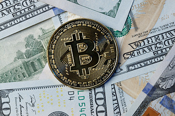 Image showing Photo bitcoin on dollar bills