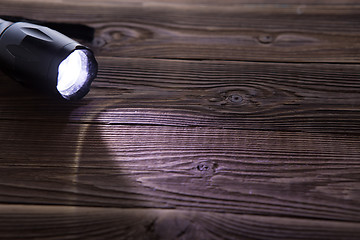 Image showing Wooden background with flashlight on