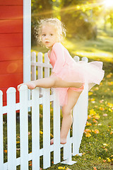 Image showing The little girl at playground against park or green forest