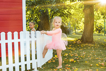 Image showing The two little girls at playground against park or green forest