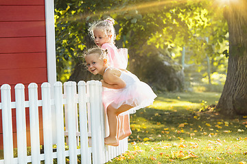 Image showing The two little girls at playground against park or green forest