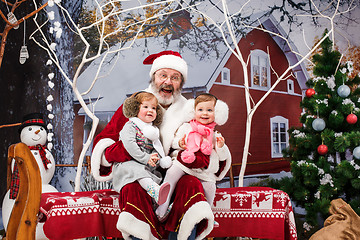 Image showing The two little girls with Santa at studio with christmas decorations