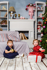 Image showing The two little girls sitting at studio with christmas decorations