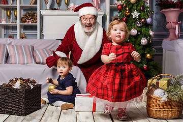 Image showing The two little girls with Santa at studio with christmas decorations