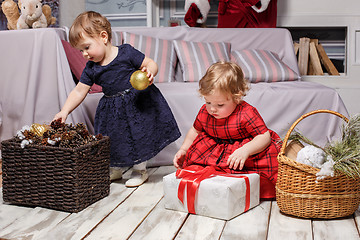 Image showing The two little girls with gifts at studio with christmas decorations