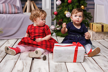 Image showing The two little girls sitting at studio with christmas decorations