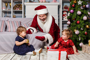 Image showing The two little girls with Santa at studio with christmas decorations