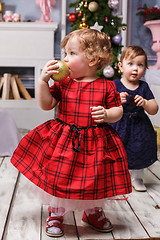 Image showing The two little girl standing at studio with christmas decorations