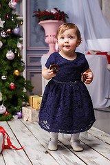 Image showing Little girl standing at studio with christmas decorations