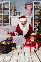 Image showing The two little girls with Santa at studio with christmas decorations