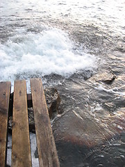Image showing Wooden steps into stird up water