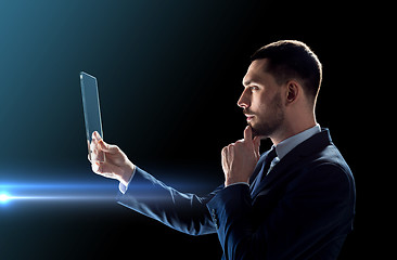 Image showing businessman working with transparent tablet pc