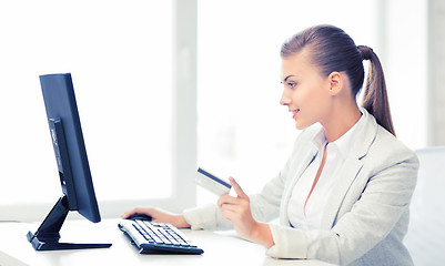 Image showing businesswoman with computer using credit card