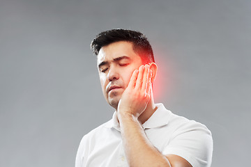 Image showing unhappy man suffering toothache