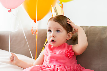 Image showing happy baby girl in crown on birthday party at home