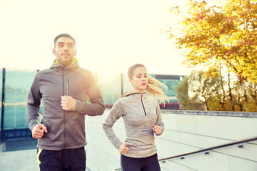 Image showing happy couple running upstairs on city stairs