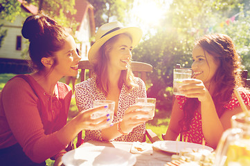 Image showing happy women with drinks at summer garden party