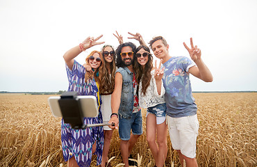 Image showing hippie friends with smartphone on selfie stick