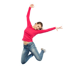 Image showing happy young woman jumping in air or dancing