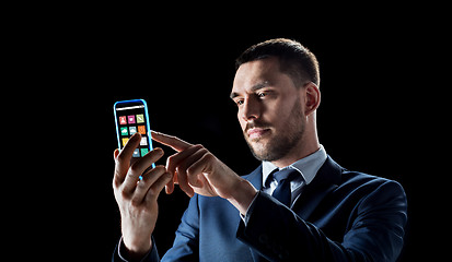 Image showing businessman with transparent smartphone