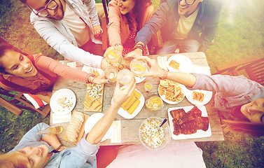 Image showing happy friends with drinks at summer garden party