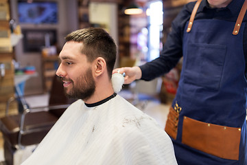 Image showing barber with brush cleaning male neck at barbershop