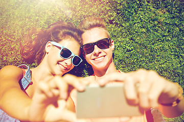 Image showing happy couple taking selfie on smartphone at summer