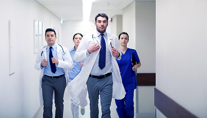 Image showing group of medics walking along hospital