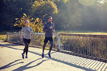 Image showing happy couple running outdoors