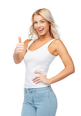 Image showing happy young woman showing thumbs up