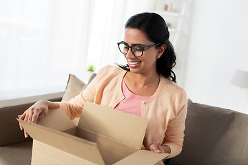 Image showing happy young indian woman with parcel box at home