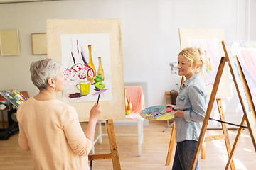 Image showing artist women with easels painting at art school