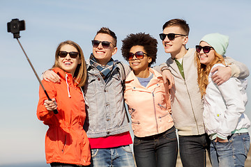 Image showing happy friends taking selfie by smartphone outdoors