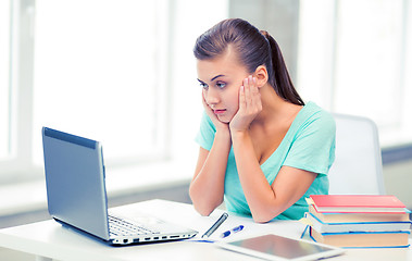 Image showing stressed student with computer at home