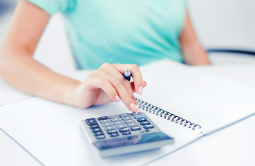 Image showing businesswoman working with calculator in office