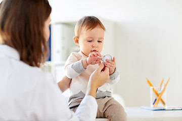 Image showing doctor with stethoscope and happy baby at clinic