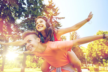 Image showing happy teenage couple having fun at summer park