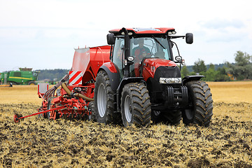 Image showing Red Case IH Tractor and Seeder on Field