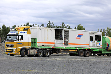 Image showing Yellow Volvo FH Semi Hauls Portable Cabin