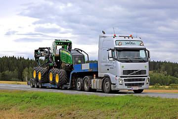 Image showing Volvo FH Semi Trailer Transports New John Deere Harvester