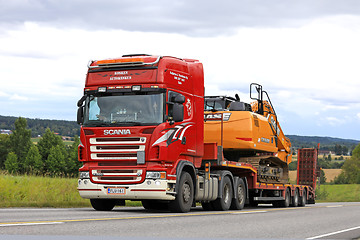 Image showing Red Scania R560 Hauls New Case Excavator