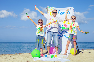 Image showing Father and children playing on the beach at the day time.