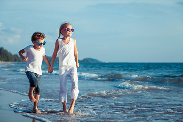 Image showing Happy children playing on the beach at the day time. 